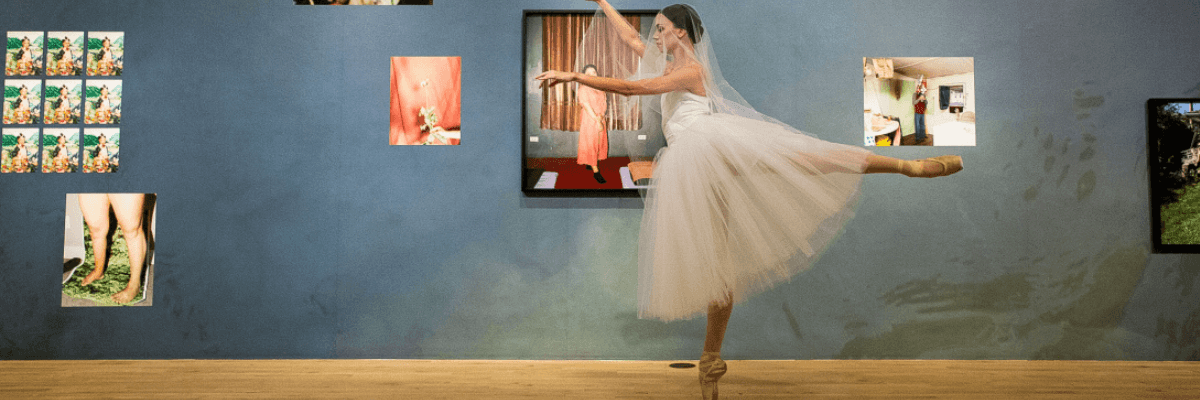 a ballerina en pointe in an art gallery