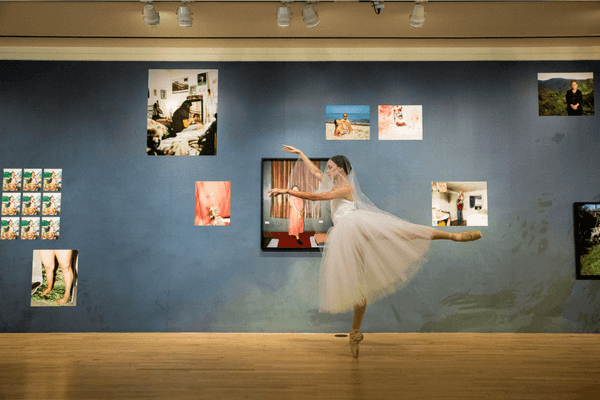 a ballerina en pointe in an art gallery