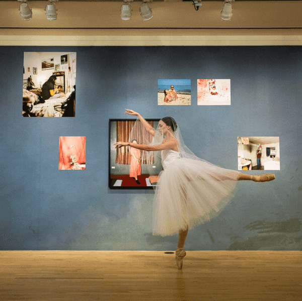 a ballerina en pointe in an art gallery