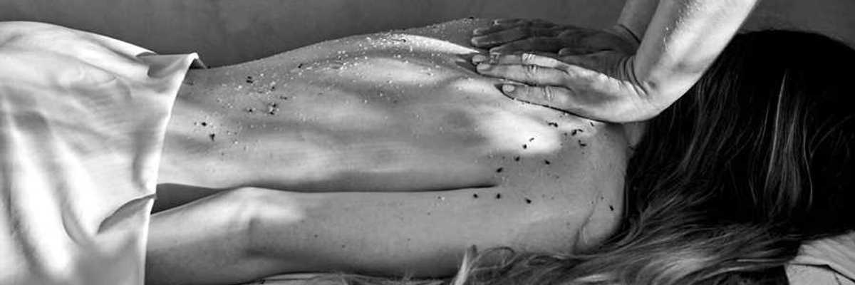 a black and white photo of a woman getting a massage