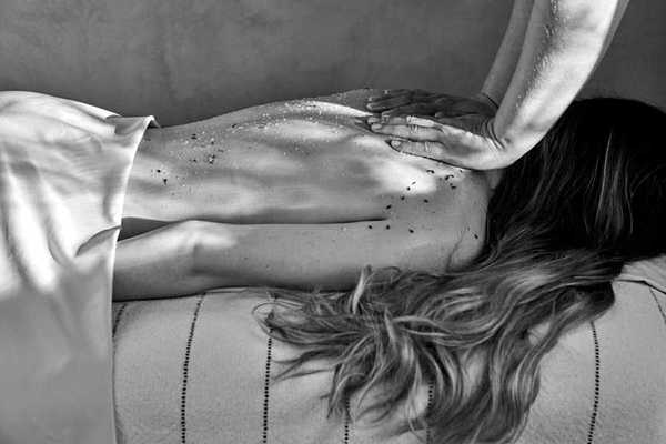 a black and white photo of a woman getting a massage