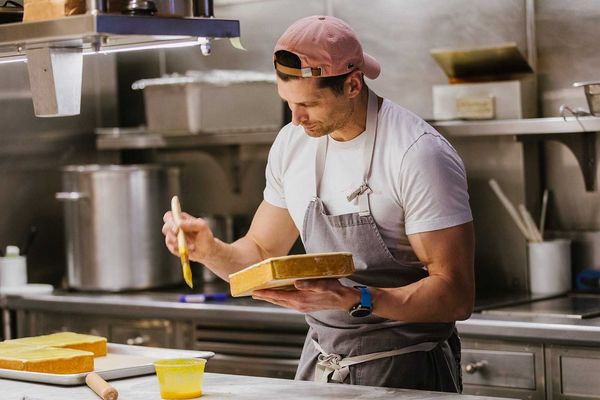 A chef with a butter brush and pate in his hand