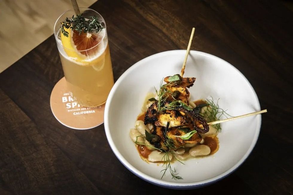 A cocktail and a meal on a table