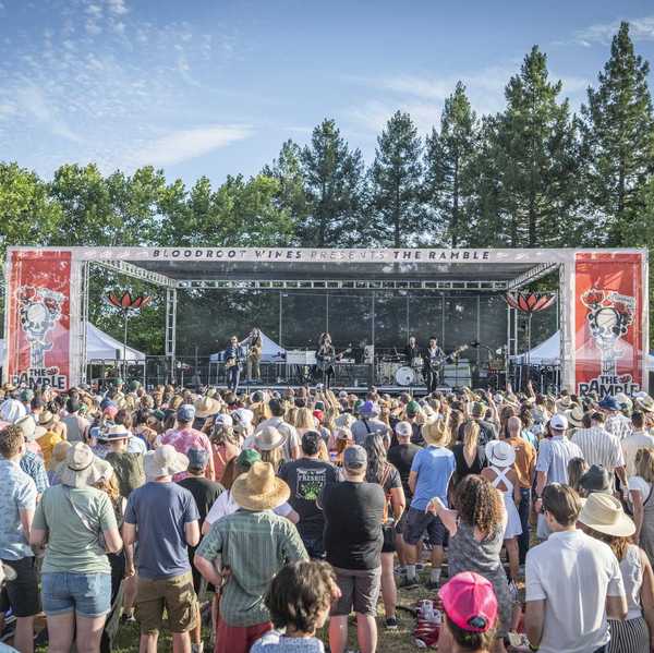 a crowd of festival goers watching a musical act on stage