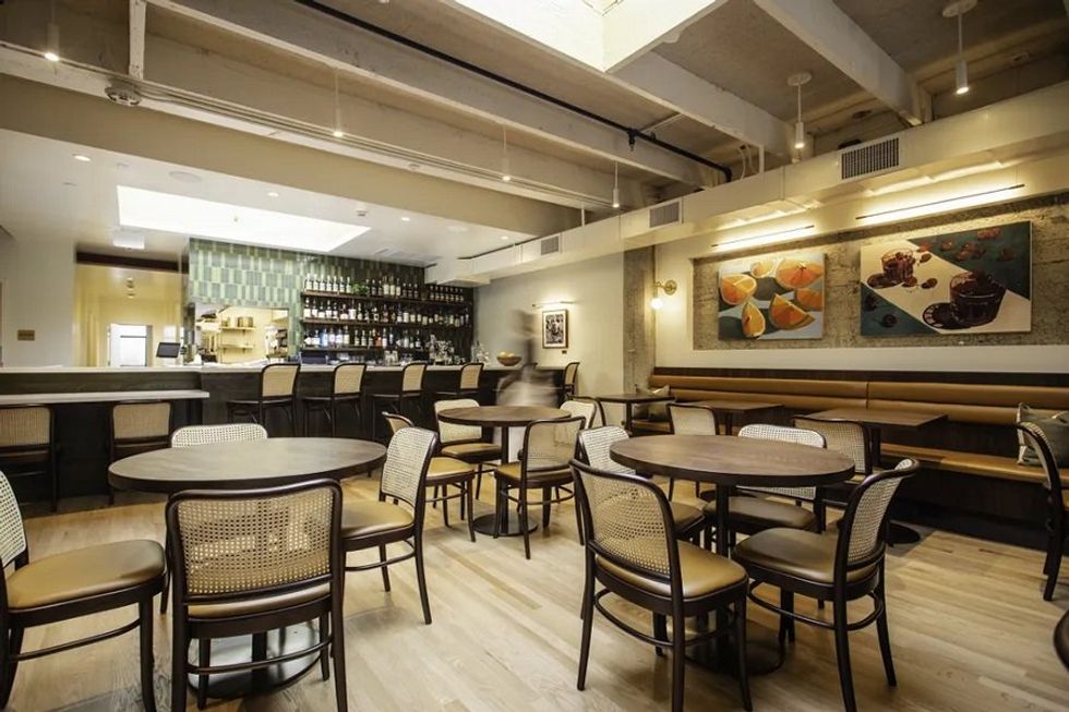 A dining room with bar in background