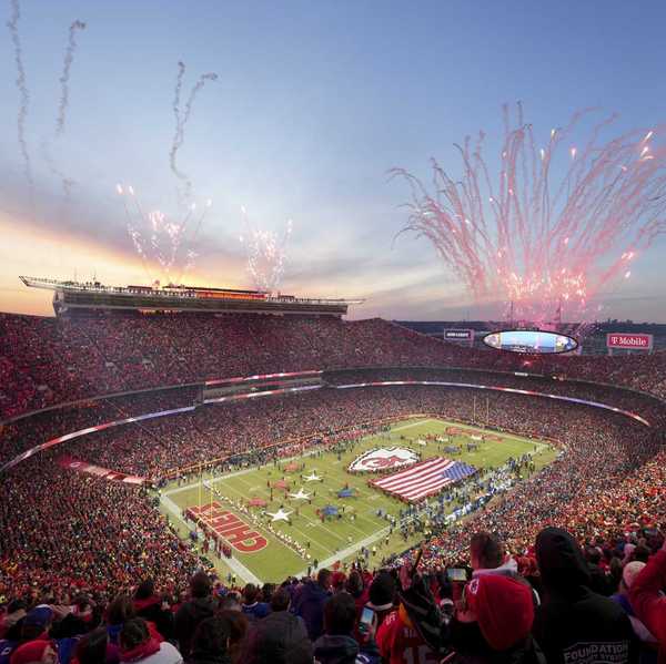 a football arena with stands full of fans and fireworks in the sky