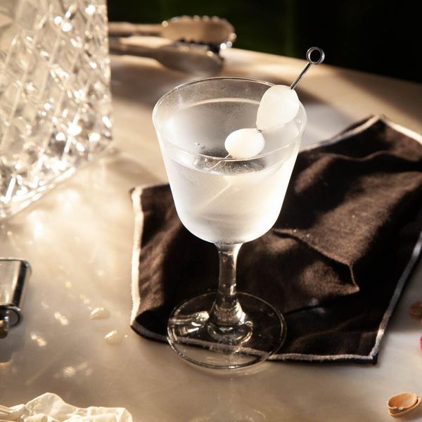 a gin cocktail in a glass with onions