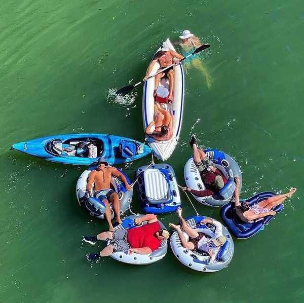 a group of inflatable rafts with people in them on a river float trip