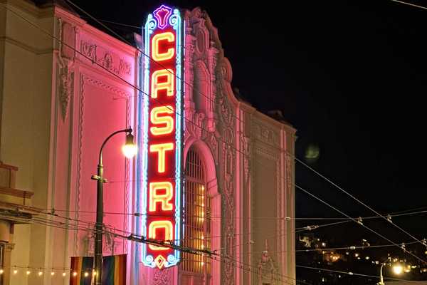 a historic movie theater with a glowing sign that reads Castro