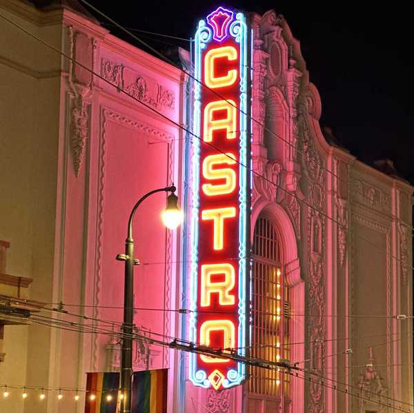 a historic movie theater with a glowing sign that reads Castro