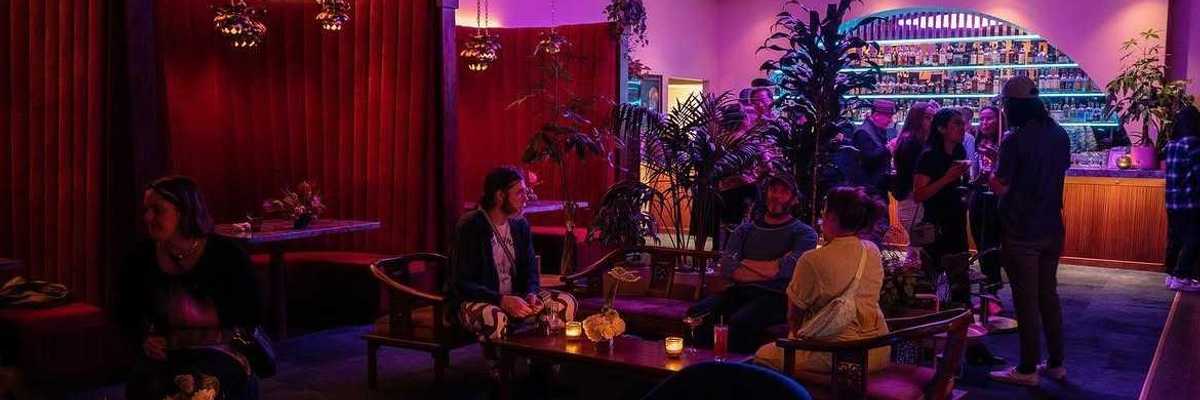 a lounge with pink lights and a mid-century Chinatown aesthetic