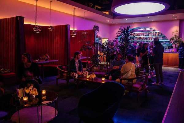 a lounge with pink lights and a mid-century Chinatown aesthetic
