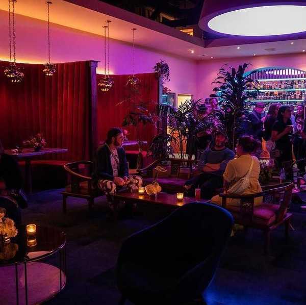 a lounge with pink lights and a mid-century Chinatown aesthetic