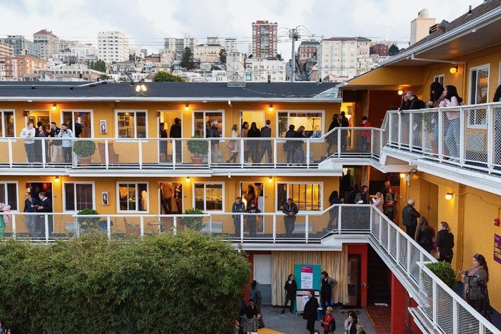a motel courtyard with people on balconies