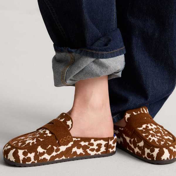 a pair of cow print velvety half loafer-half clog shoes
