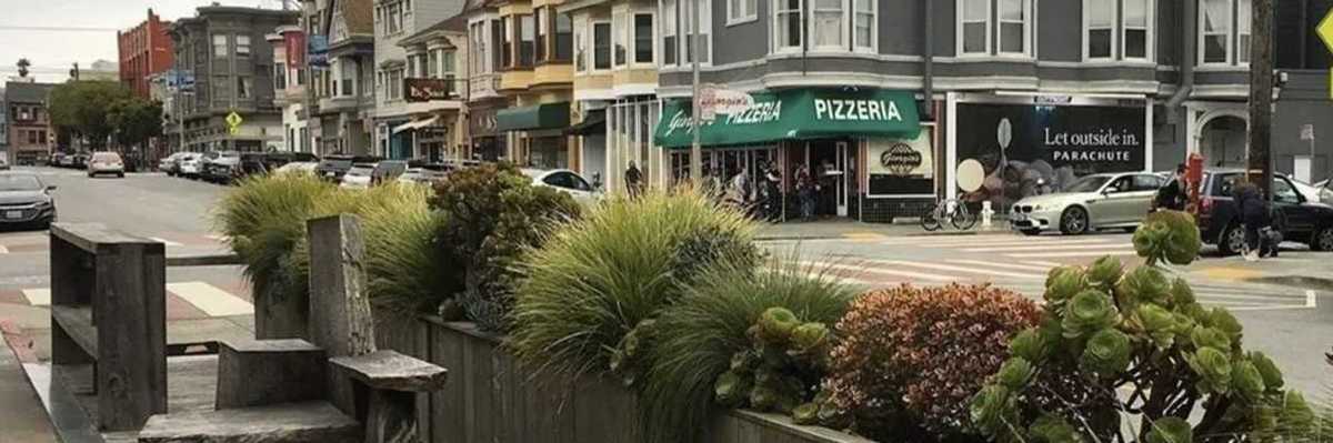 a parklet and street with Victorian-era buildings in San Francisco's Inner Richmond neighborhood
