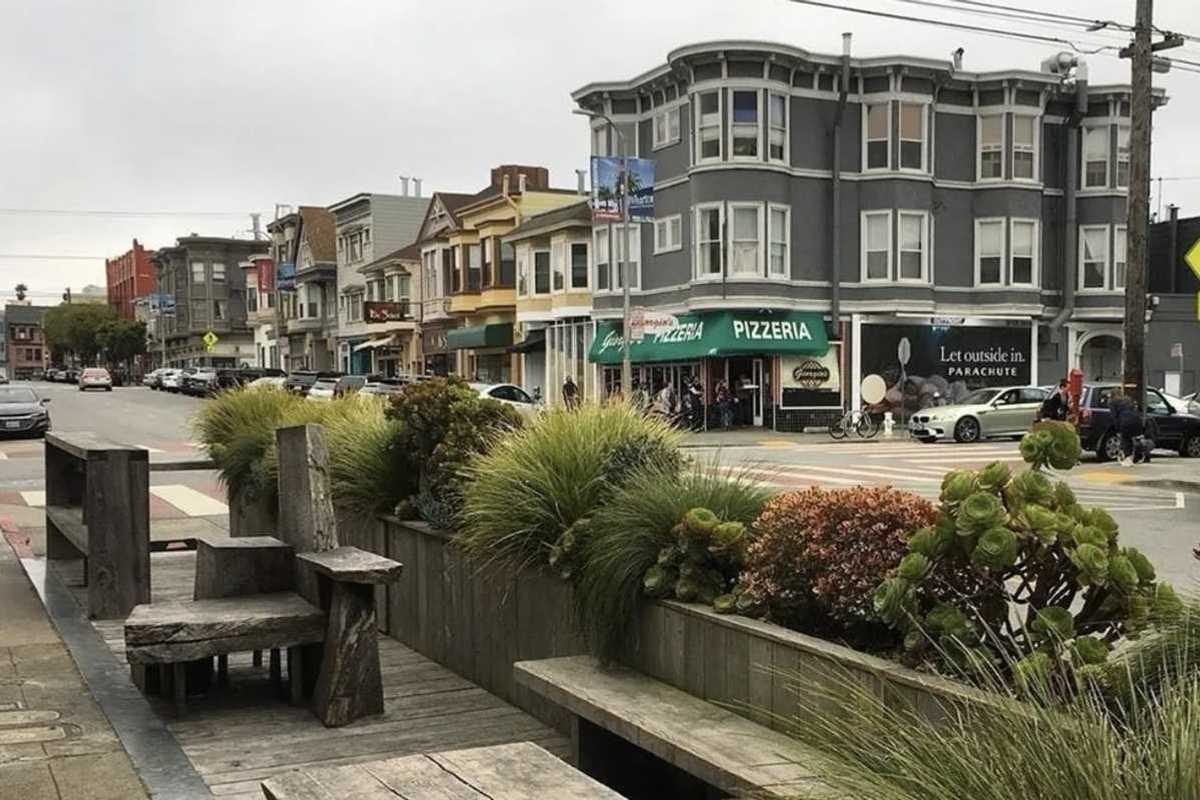 a parklet and street with Victorian-era buildings in San Francisco's Inner Richmond neighborhood