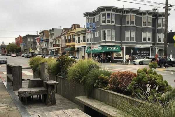 a parklet and street with Victorian-era buildings in San Francisco's Inner Richmond neighborhood