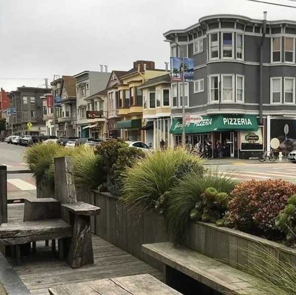 a parklet and street with Victorian-era buildings in San Francisco's Inner Richmond neighborhood
