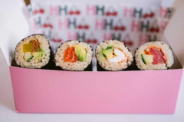 a pink box filled with Australian-style handrolls