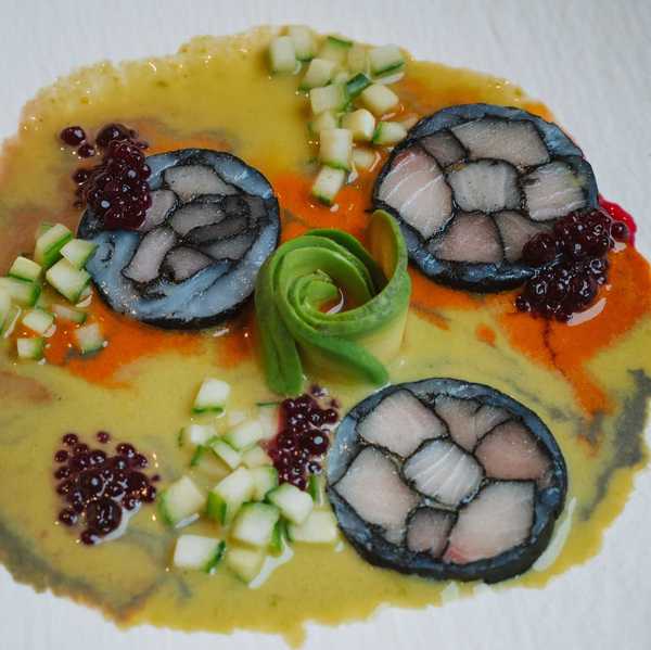 a plate with raw fish aguachile in a citrus marinade with cucumbers and avocado
