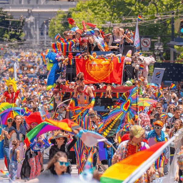 a Pride parade with tons of people in rainbow colors