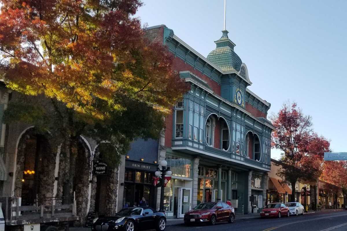 a quaint small town main street with a historical building