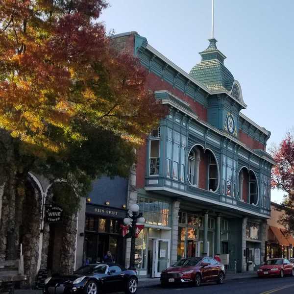 a quaint small town main street with a historical building