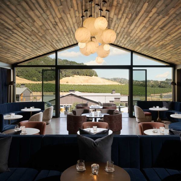 a rooftop dining area with a view of vineyards and a wood ceiling