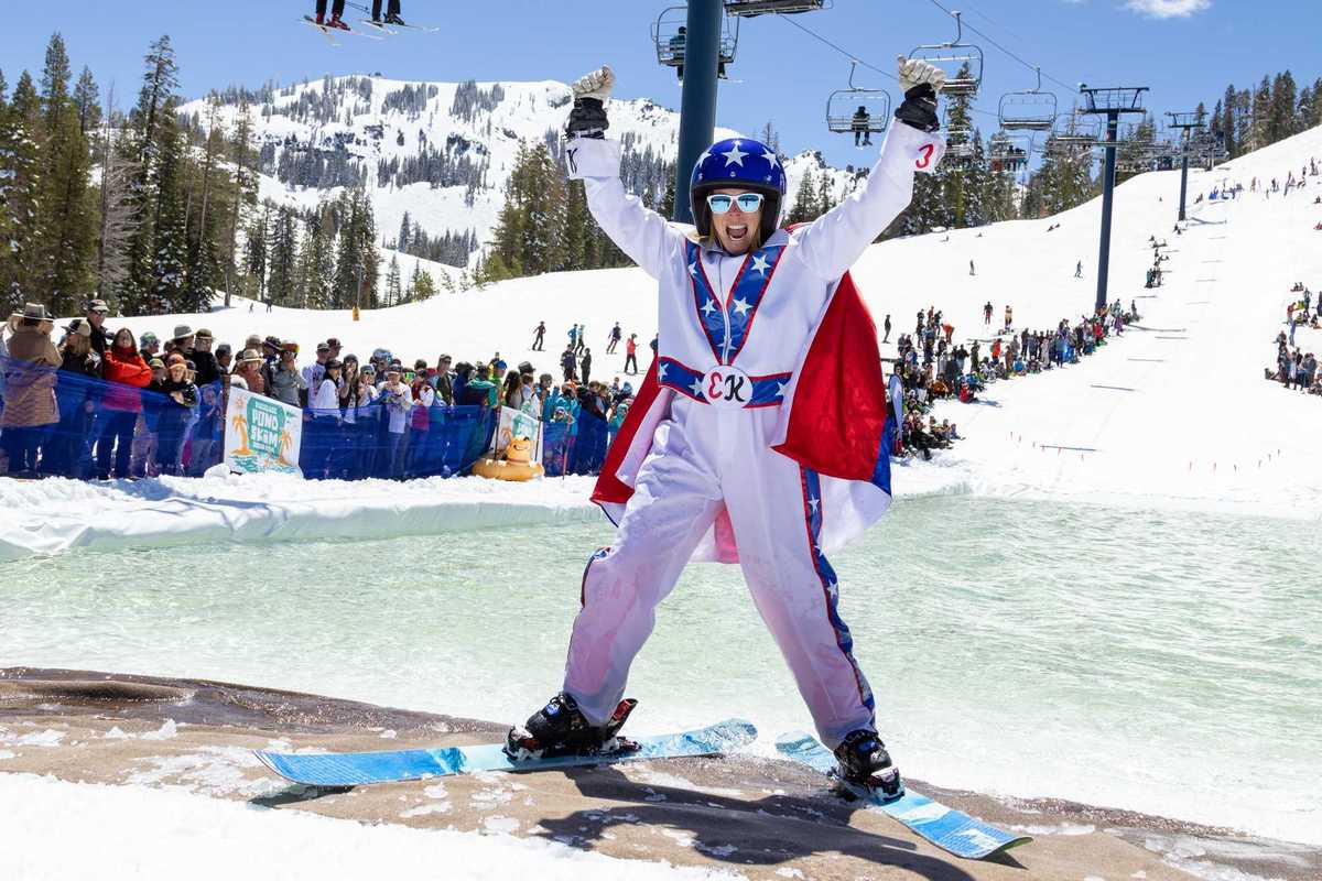 a skiier dressed like Evel Knieval at the edge of a pond