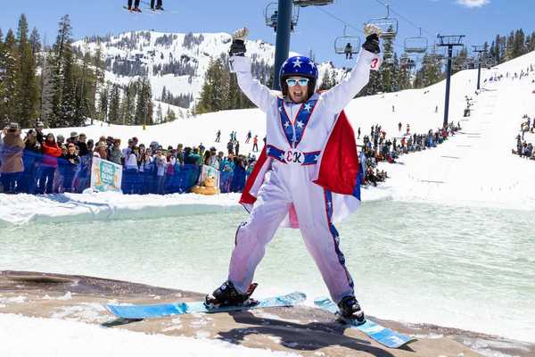 a skiier dressed like Evel Knieval at the edge of a pond