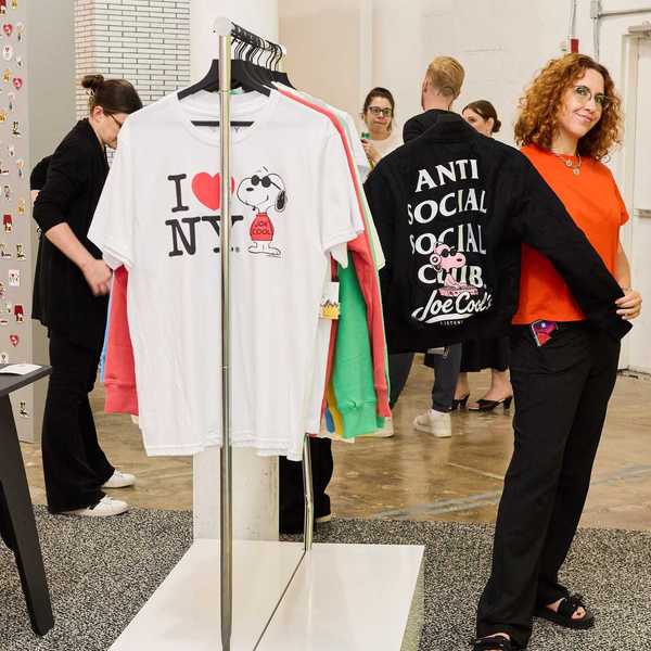a Snoopy-themed shop with a woman holding up a Snoopy jacket and other shoppers around
