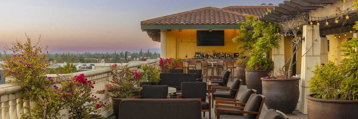 a Spanish Colonial Revival-style rooftop bar in the sunset