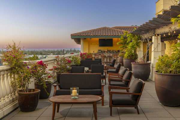 a Spanish Colonial Revival-style rooftop bar in the sunset