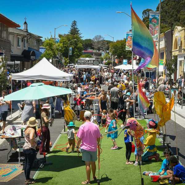 a street festival with families playing a game in the foreground