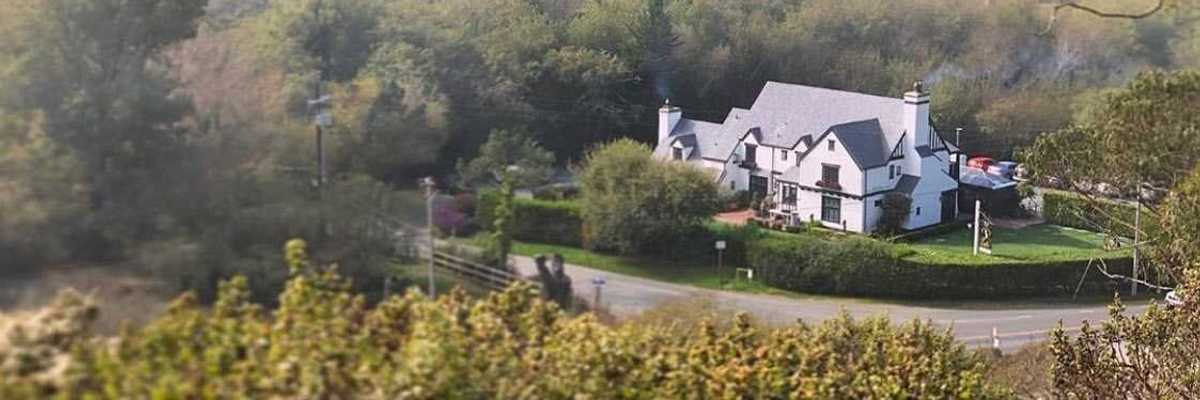 a tudor-style inn against natural hills and trees