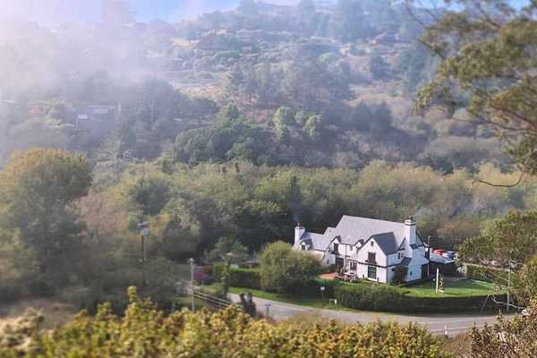 a tudor-style inn against natural hills and trees
