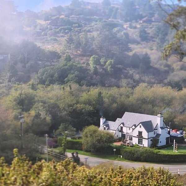 a tudor-style inn against natural hills and trees
