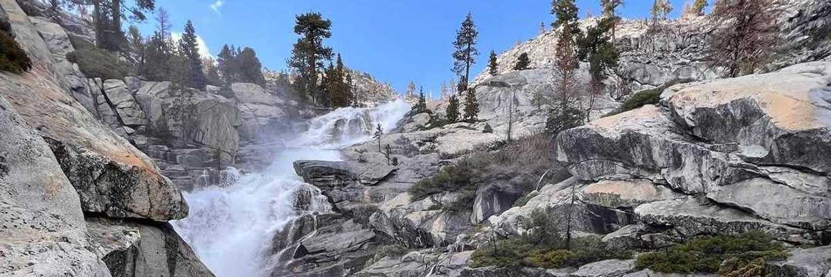 a waterfall running through granite rocks