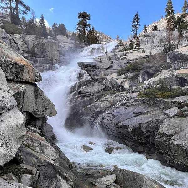 a waterfall running through granite rocks
