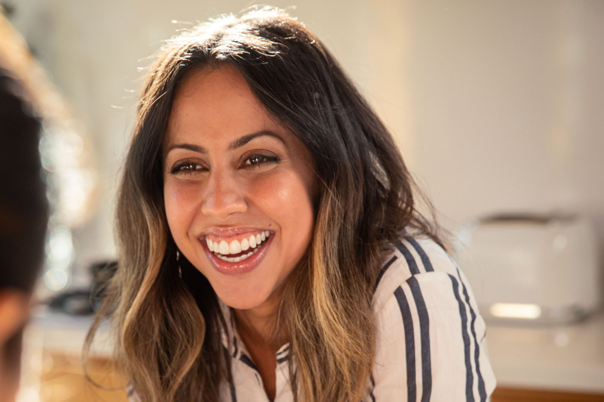 A woman smiling with an invisible teeth aligner on her teeth