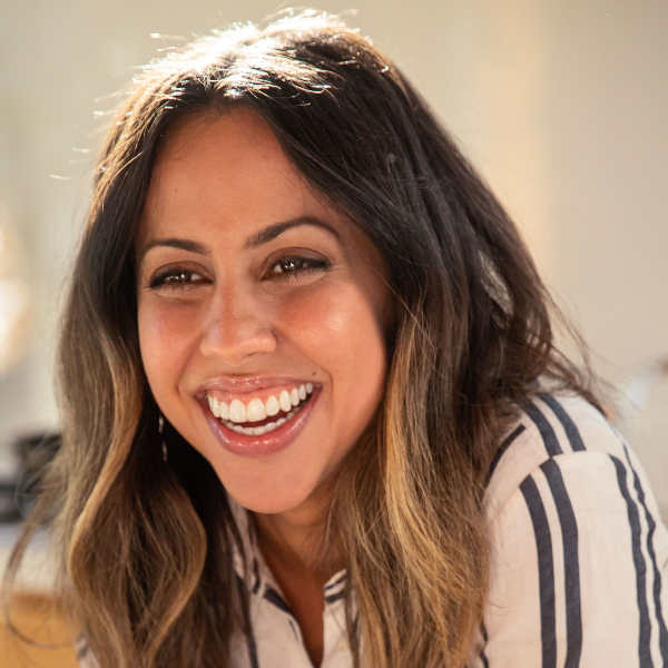 A woman smiling with an invisible teeth aligner on her teeth