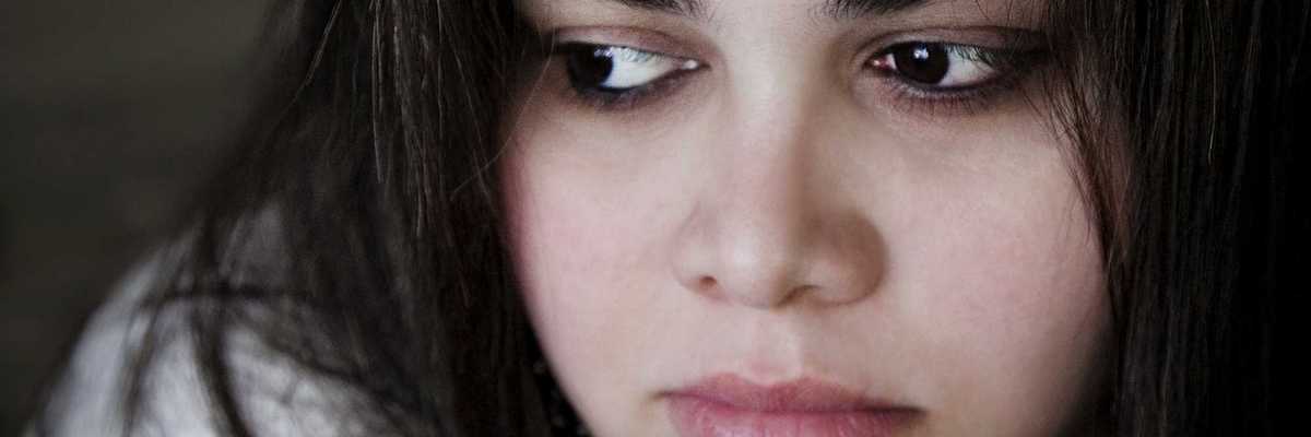 a woman with dark hair, dark eyes, and dark eyebrows