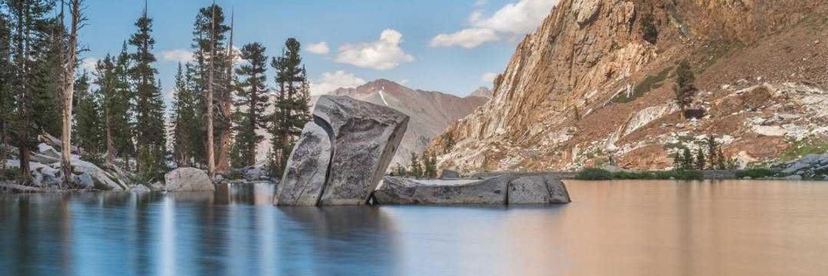 An alpine lake with huge rocks sticking out of the water
