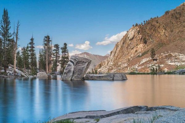 An alpine lake with huge rocks sticking out of the water