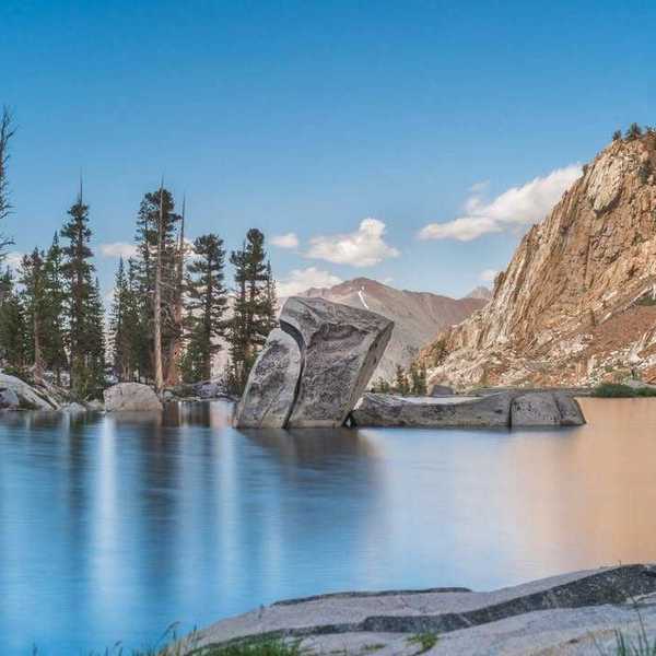 An alpine lake with huge rocks sticking out of the water