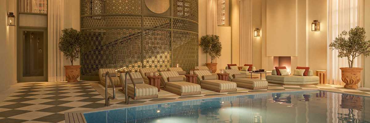 an Art Deco-inspired indoor pool with gilded accents and glamorous loungers
