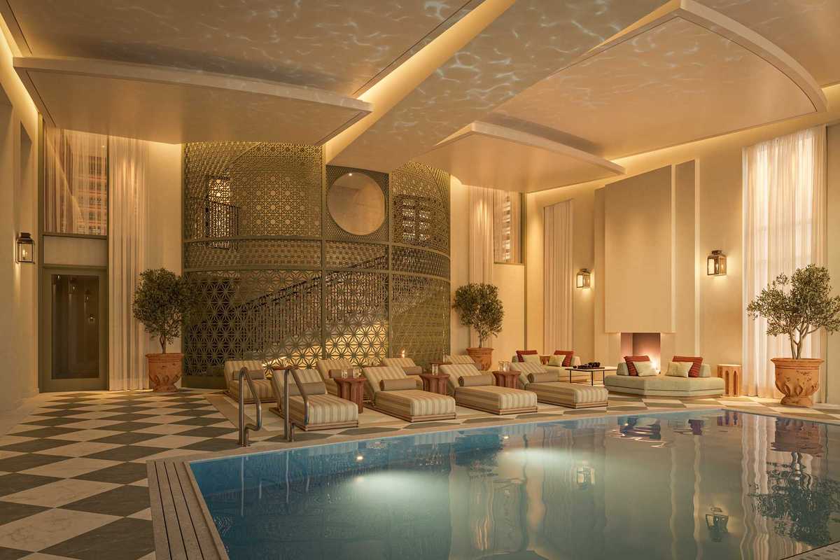 an Art Deco-inspired indoor pool with gilded accents and glamorous loungers