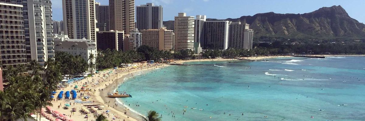 beach with turquoise water and tall buildings