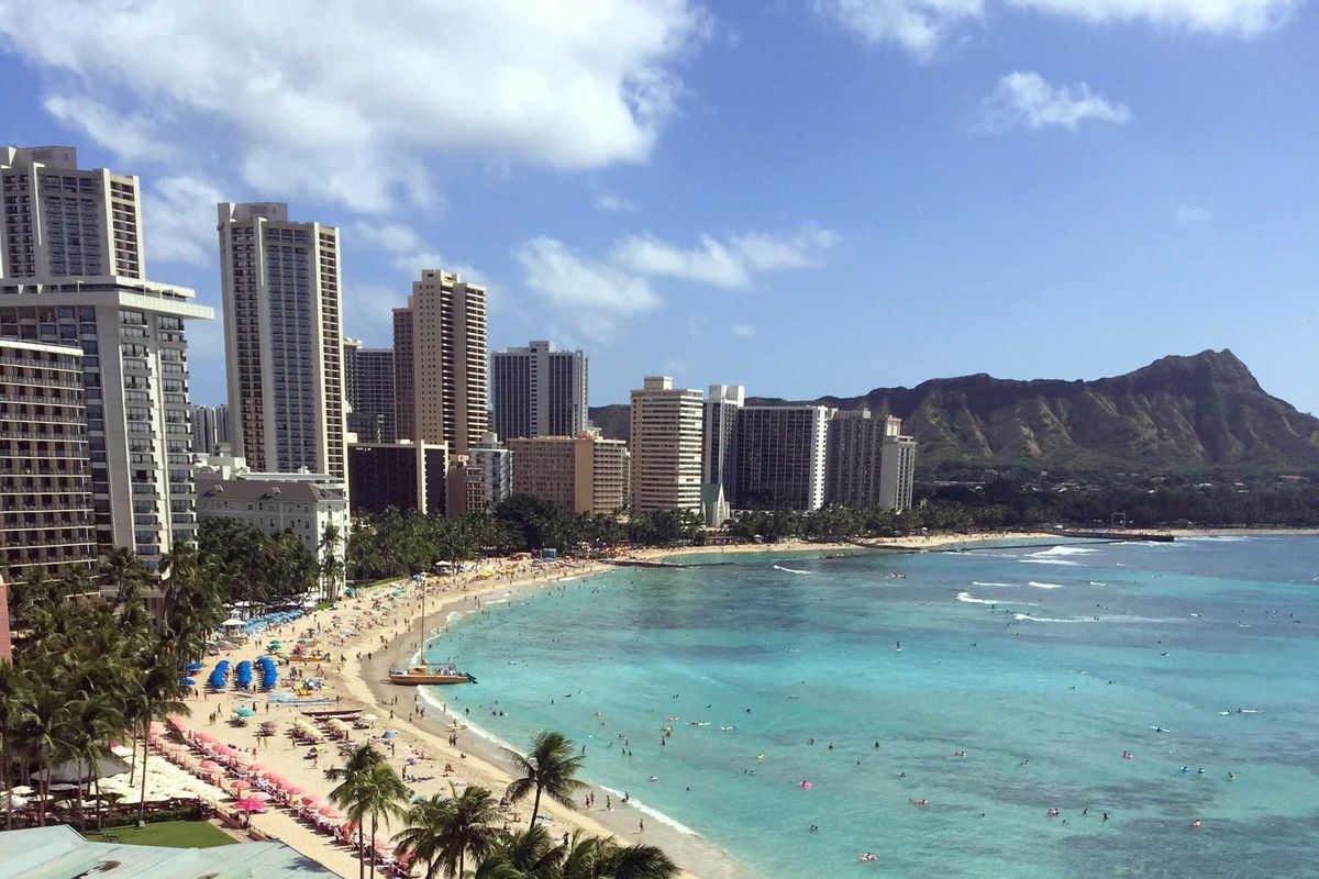 beach with turquoise water and tall buildings